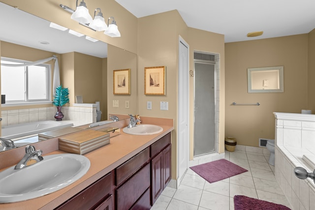 full bathroom featuring vanity, tile patterned floors, toilet, and separate shower and tub