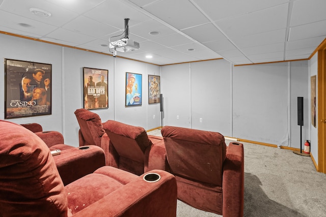 carpeted cinema with a paneled ceiling