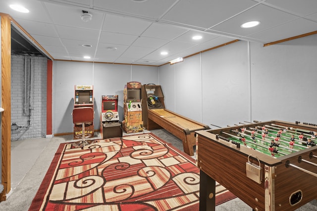 rec room with a drop ceiling and light colored carpet