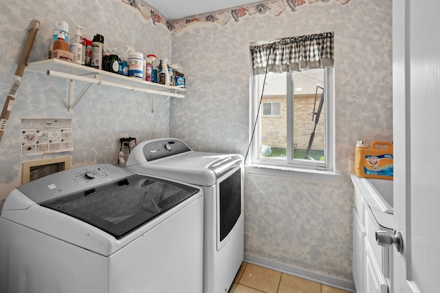 clothes washing area featuring washing machine and dryer and light tile patterned floors