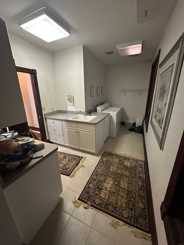 bathroom featuring separate washer and dryer, sink, and tile patterned flooring