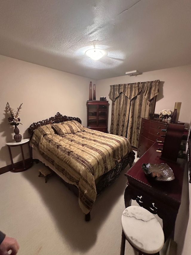 bedroom with carpet floors and a textured ceiling