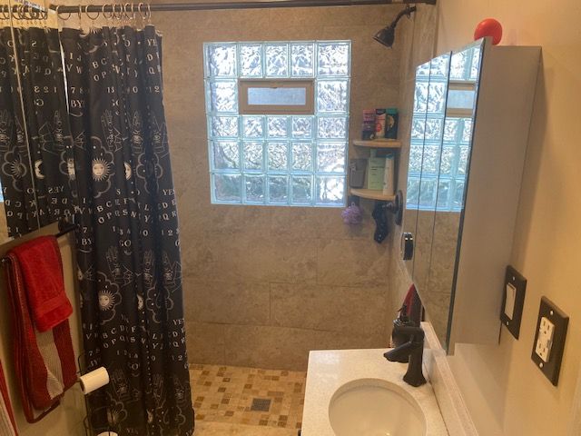 bathroom with vanity and curtained shower