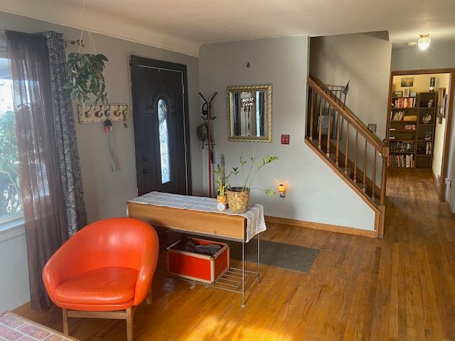 foyer entrance with a wealth of natural light and hardwood / wood-style floors