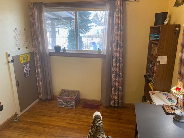 living area with hardwood / wood-style flooring