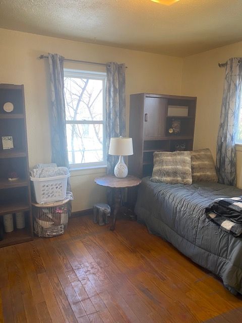 bedroom featuring dark hardwood / wood-style floors and a textured ceiling