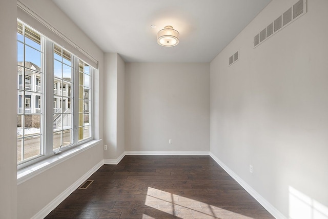 empty room featuring dark hardwood / wood-style flooring