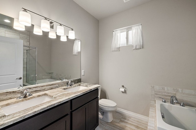 full bathroom featuring vanity, toilet, and independent shower and bath