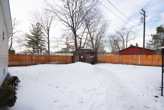 snowy yard with a storage unit