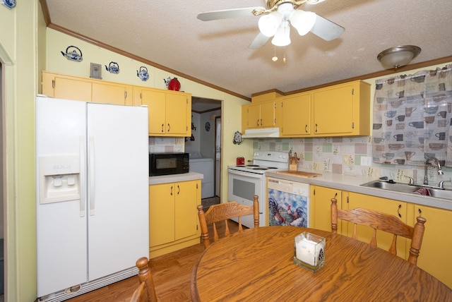 kitchen with sink, vaulted ceiling, ornamental molding, white appliances, and decorative backsplash