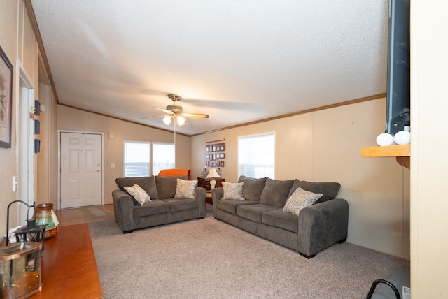 carpeted living room with lofted ceiling, crown molding, plenty of natural light, and ceiling fan