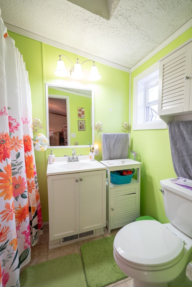 bathroom featuring vanity, toilet, crown molding, tile patterned floors, and a textured ceiling