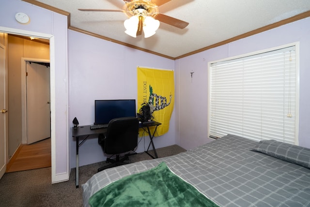 bedroom featuring crown molding, ceiling fan, carpet floors, and a textured ceiling