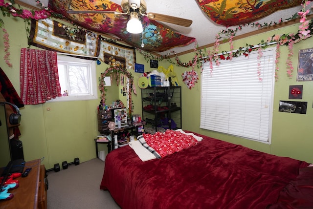 bedroom featuring ceiling fan and carpet