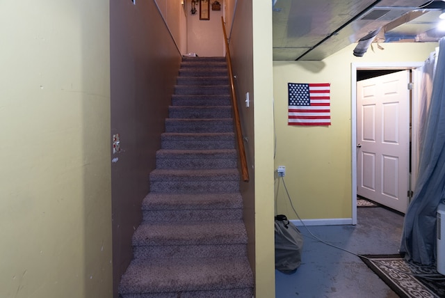 stairway featuring concrete floors