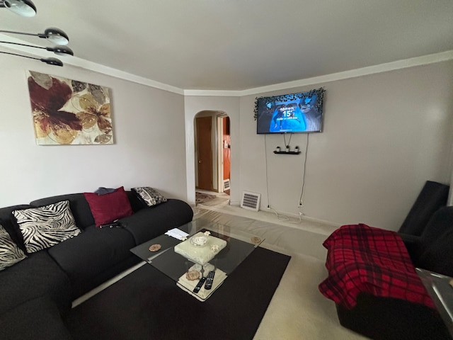 carpeted living room featuring crown molding