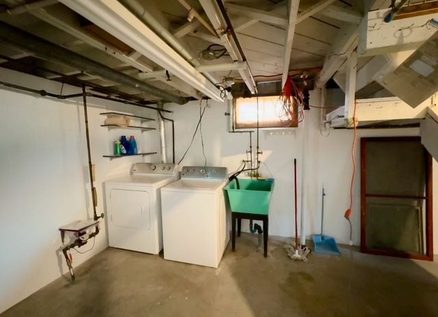 basement featuring independent washer and dryer and sink