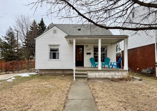 bungalow-style home with a front yard and a porch