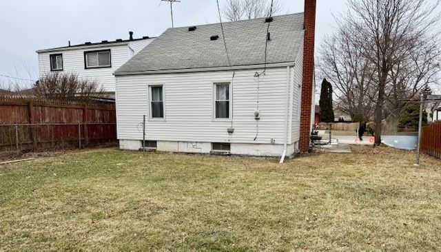 rear view of house with a yard