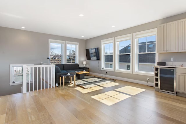 living room featuring wine cooler and light hardwood / wood-style flooring