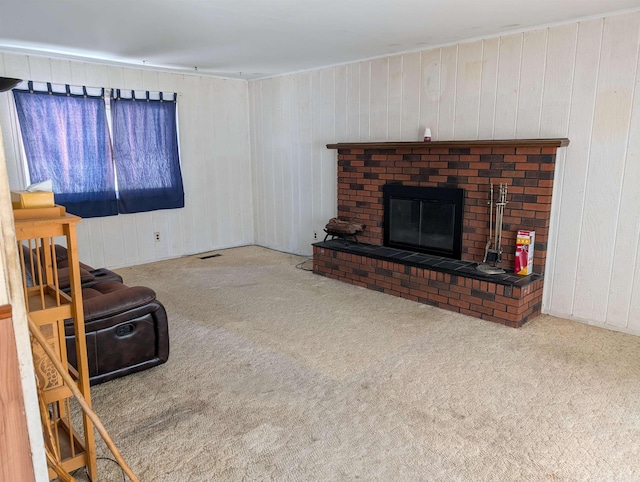 living room featuring carpet flooring, a fireplace, and wood walls