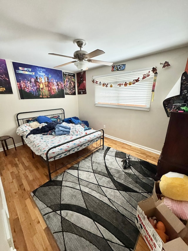 bedroom featuring hardwood / wood-style flooring and ceiling fan