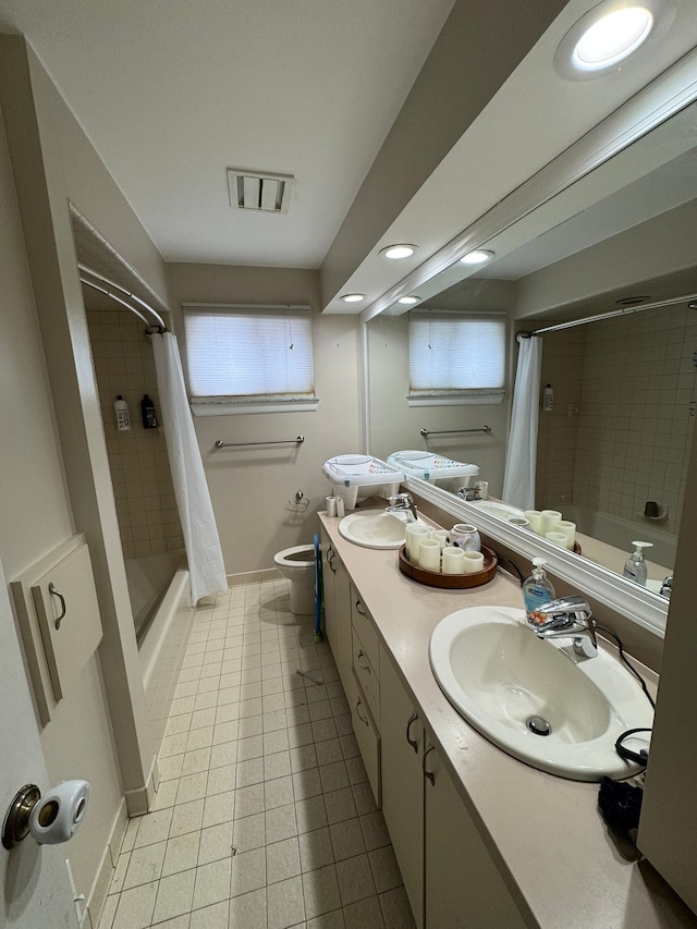 full bathroom featuring tile patterned flooring, vanity, shower / tub combo, and toilet