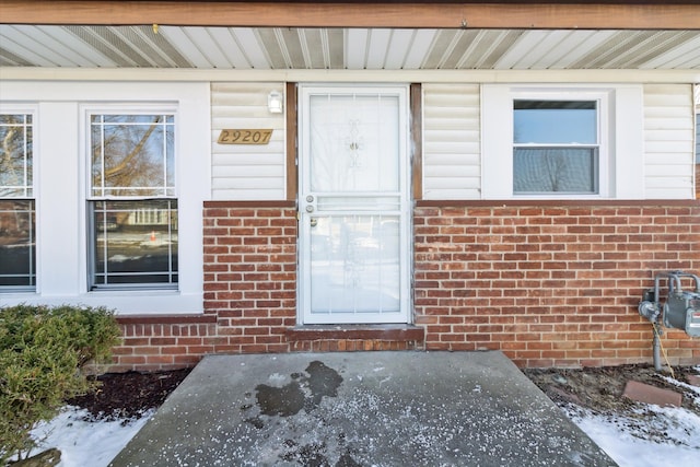 view of snow covered property entrance