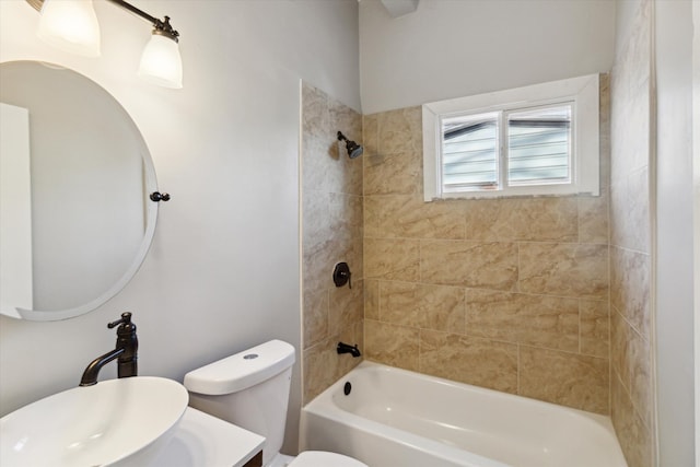 full bathroom with tiled shower / bath, toilet, and sink