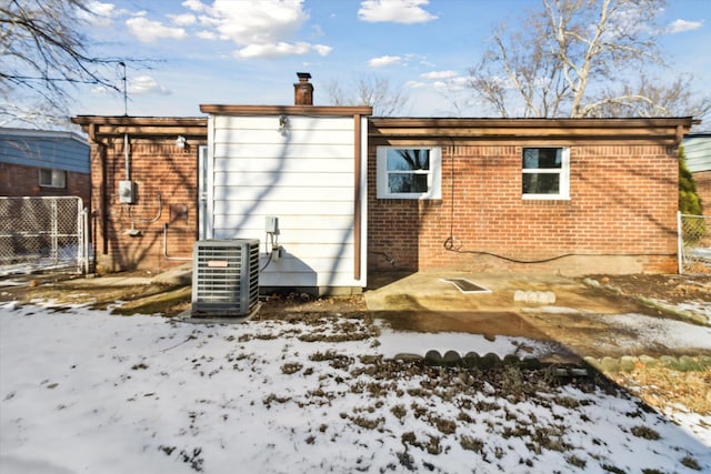 snow covered property featuring central air condition unit