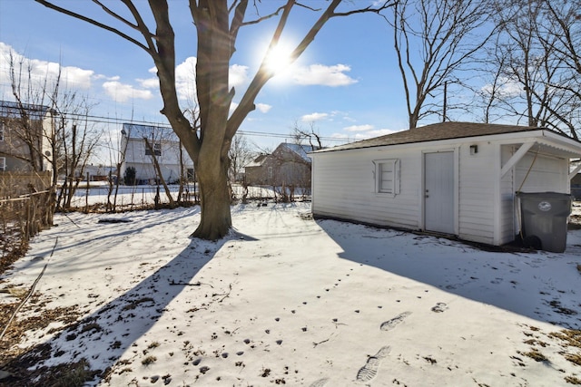 yard layered in snow with an outdoor structure