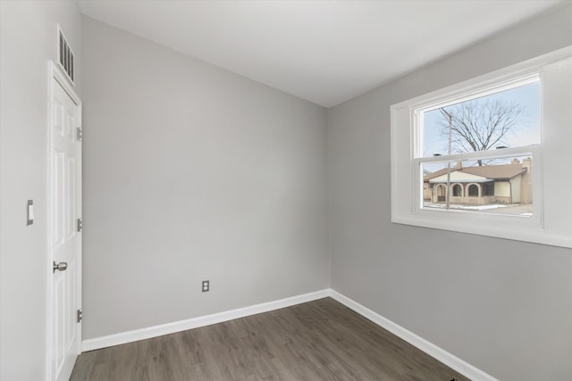 spare room with dark hardwood / wood-style floors