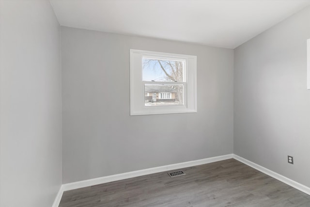 spare room with dark hardwood / wood-style flooring