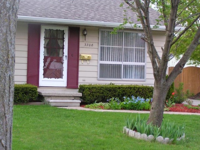 doorway to property featuring a yard