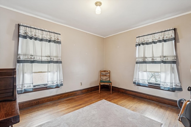 unfurnished room featuring hardwood / wood-style flooring and crown molding