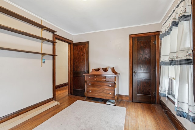 bedroom featuring hardwood / wood-style flooring and crown molding