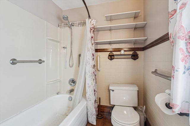 bathroom with toilet, shower / tub combo, and tile walls