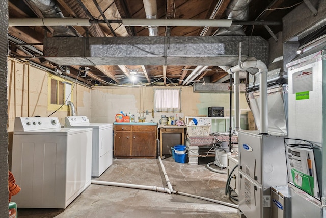 basement featuring washer and dryer and heating unit