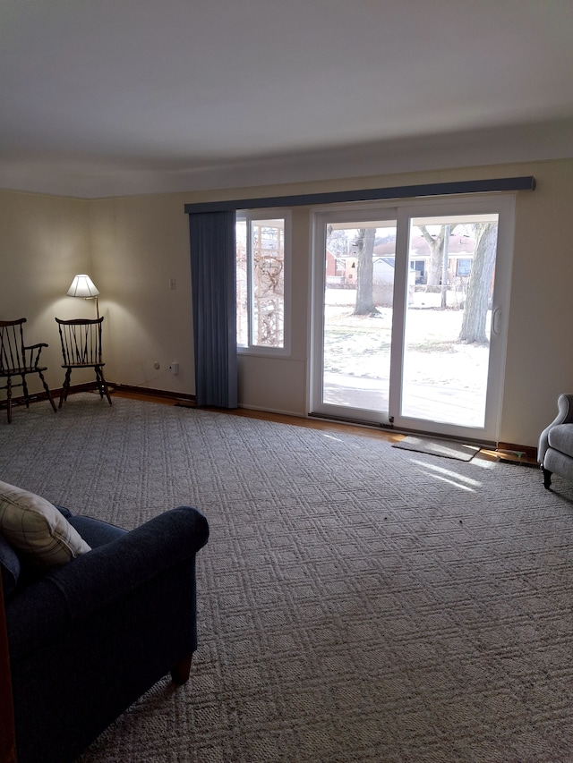 carpeted living room featuring plenty of natural light