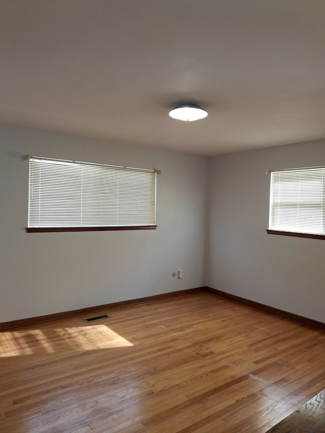 empty room with light hardwood / wood-style flooring