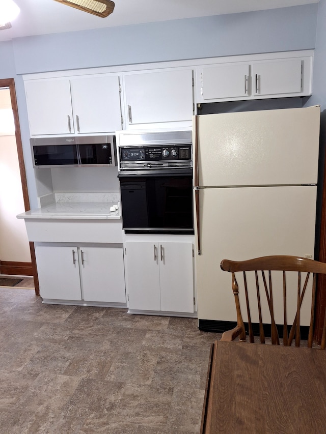 kitchen featuring white cabinetry, white fridge, oven, and extractor fan