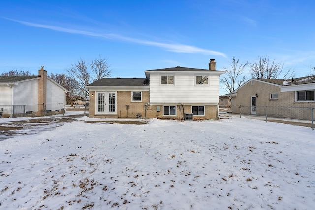 view of snow covered back of property