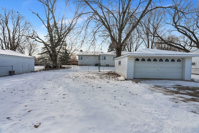 exterior space featuring a garage and an outdoor structure