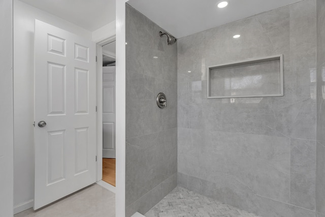 bathroom with tiled shower