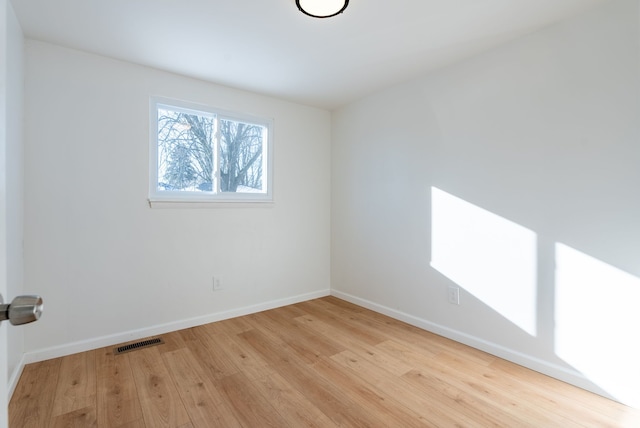 unfurnished room with light wood-type flooring