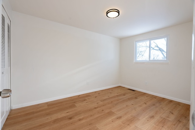 unfurnished room with light hardwood / wood-style flooring