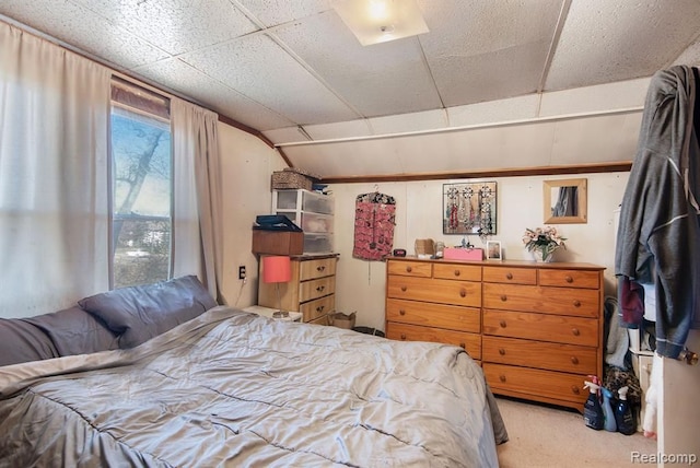 carpeted bedroom with vaulted ceiling