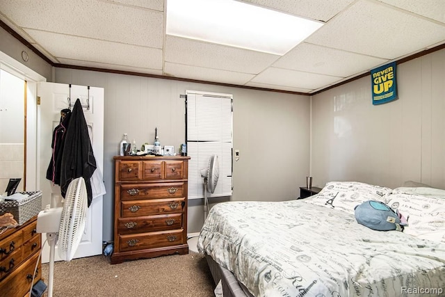 carpeted bedroom featuring a drop ceiling