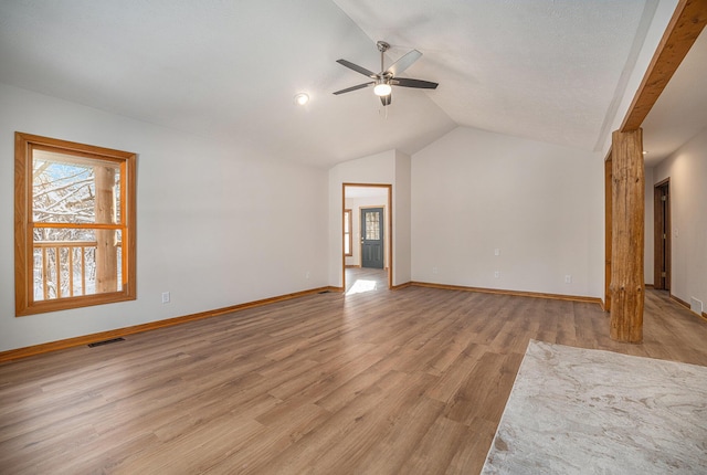 unfurnished living room featuring ceiling fan, vaulted ceiling, and light hardwood / wood-style flooring