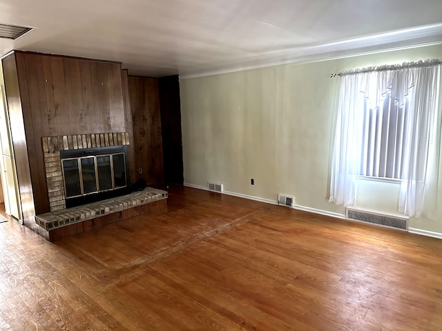 unfurnished living room featuring wood-type flooring and a fireplace